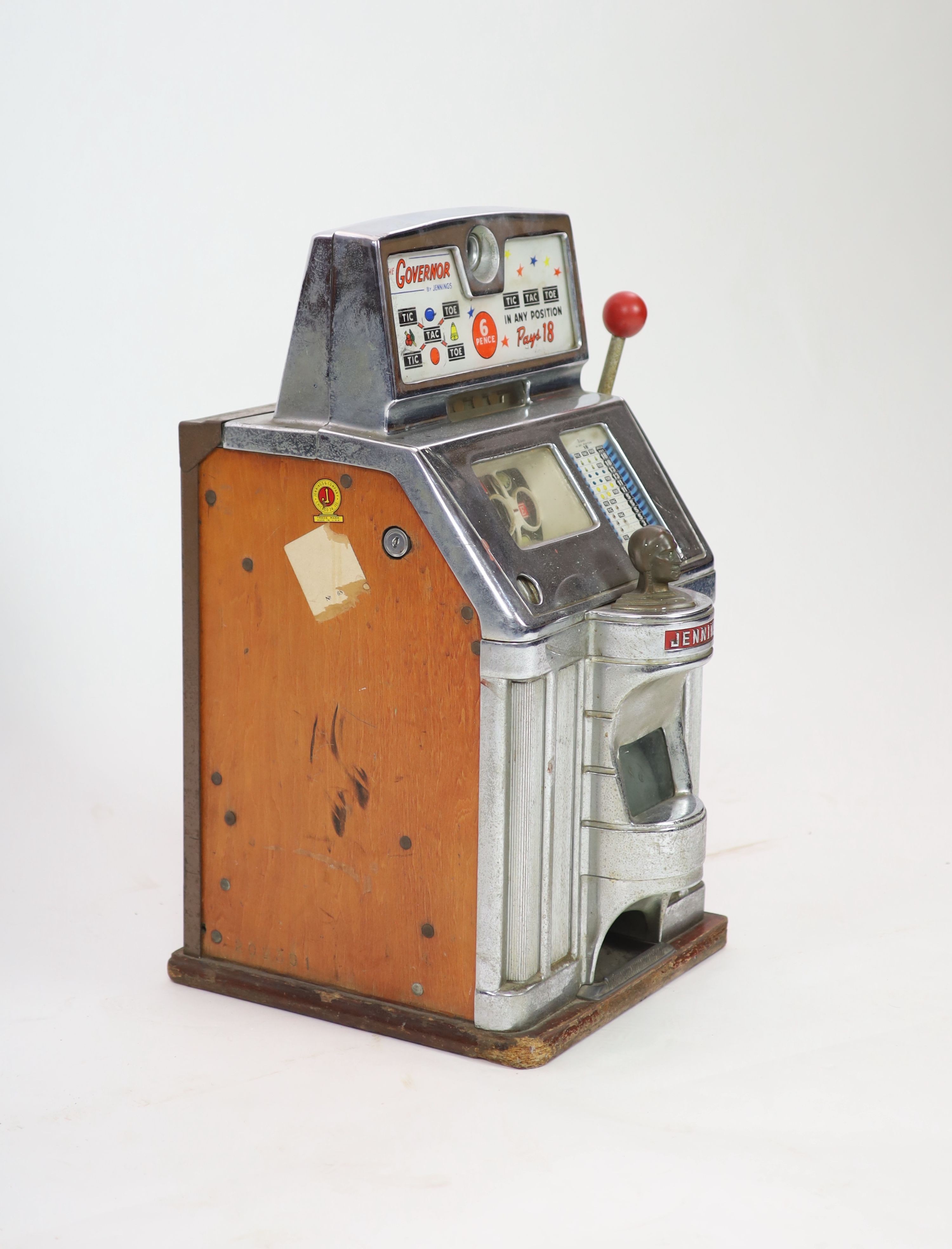 A Jennings 'The Governor' Tic Tac Toe penny slot machine, width 39cm depth 44cm height 69cm